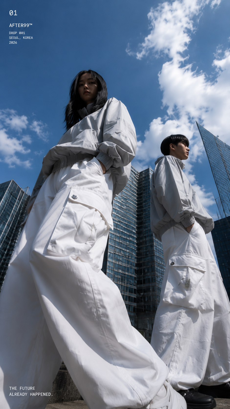 Two models in white technical streetwear under a blue Seoul sky